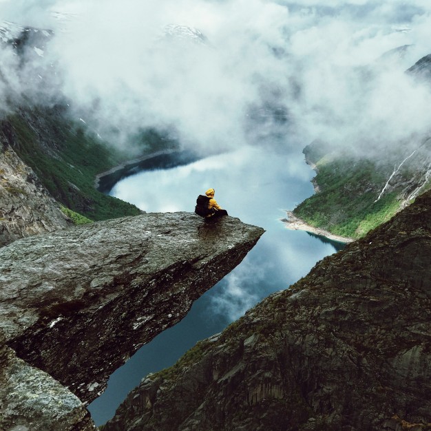 man-sits-at-the-end-of-trolltunga-before-the-mountains_1304-5318.jpg
